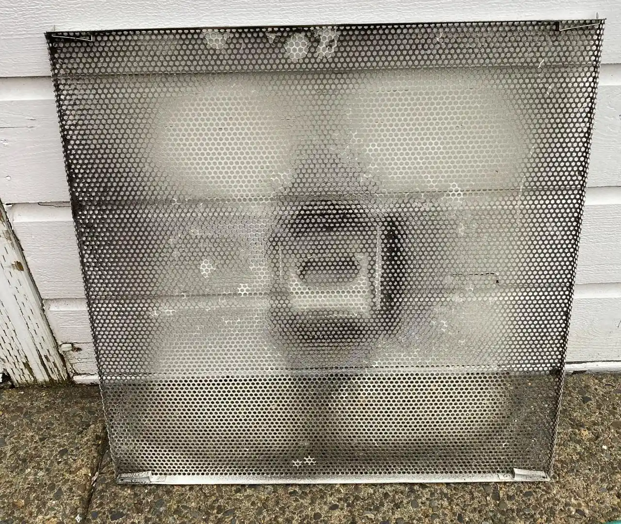 Clogged ventilation grille at a Vancouver hair salon covered in dust and hair product residue before cleaning