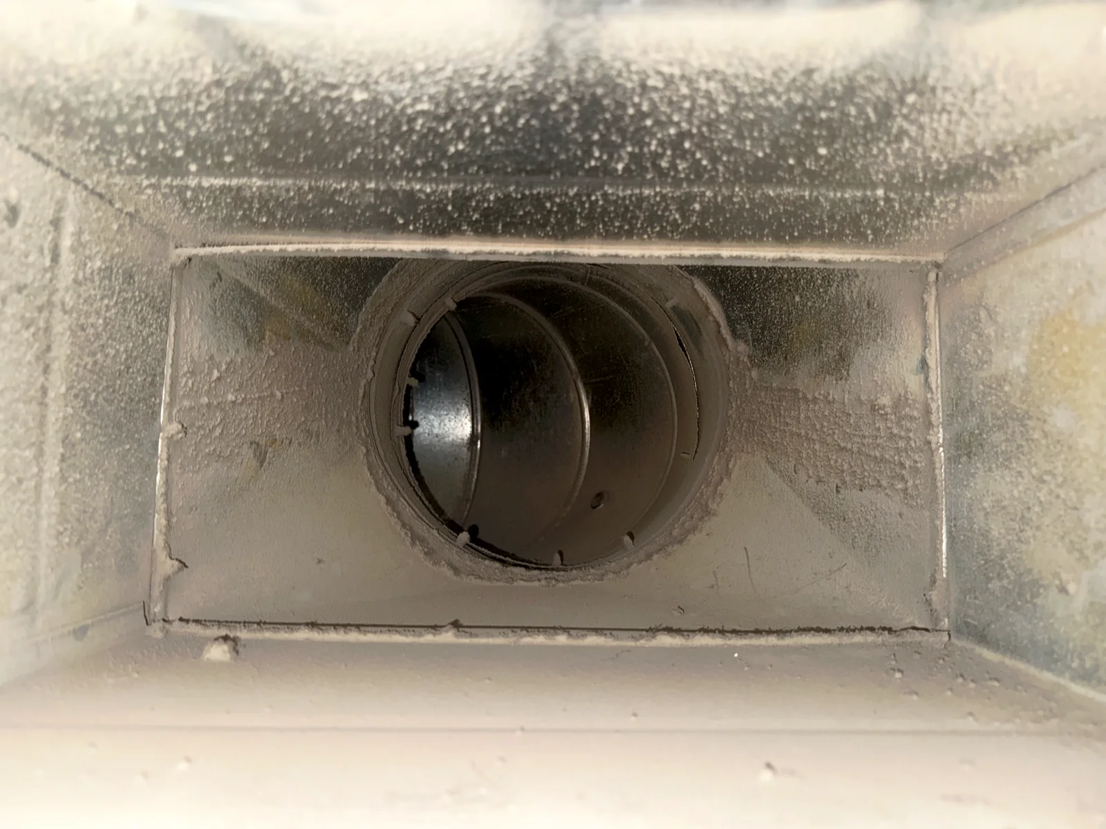 Interior of supply duct before cleaning — dust-coated metal at VOA Oregon Men's Residential Center